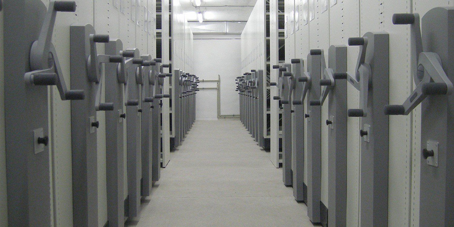 Mobile archive shelving installation at UniCredit Central with hand-wheel operated mobile units.